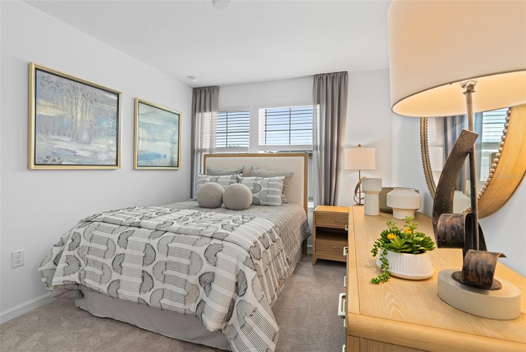 3639 Southeast 37th Ave Road Ocala, FL 34480 - Photo 9 of 61 a bedroom with a bed and a chandelier