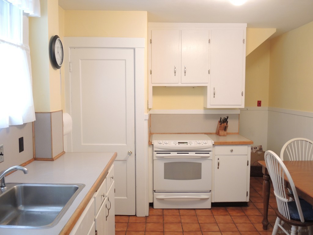 21 Lawton Road Needham, MA 02492 - Photo 8 of 28 a utility room with cabinets washer and dryer