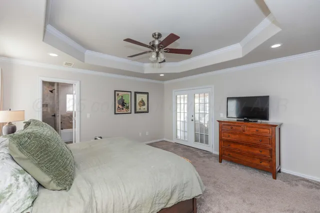 a bedroom with a bed and a television