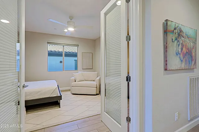 a bedroom with a bed and a painting on the wall