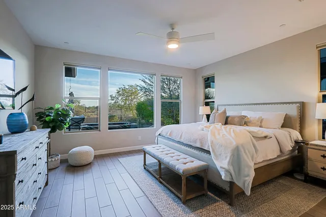 a bedroom with a bed and a potted plant