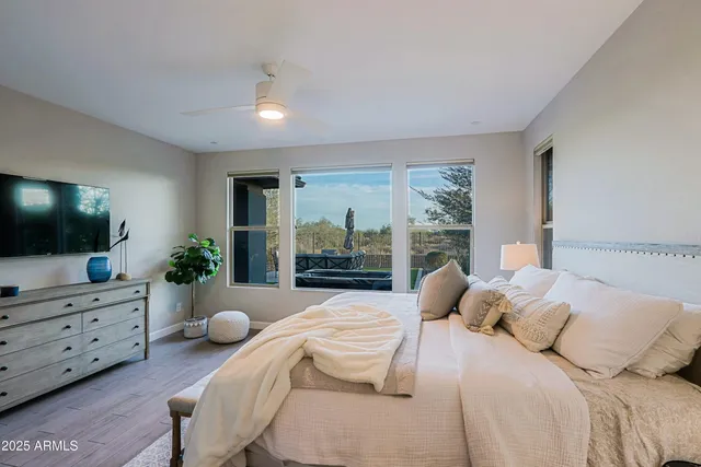 a bedroom with a bed and flat screen tv