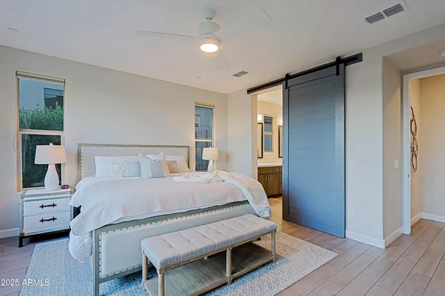 a bedroom with a bed and wooden floor