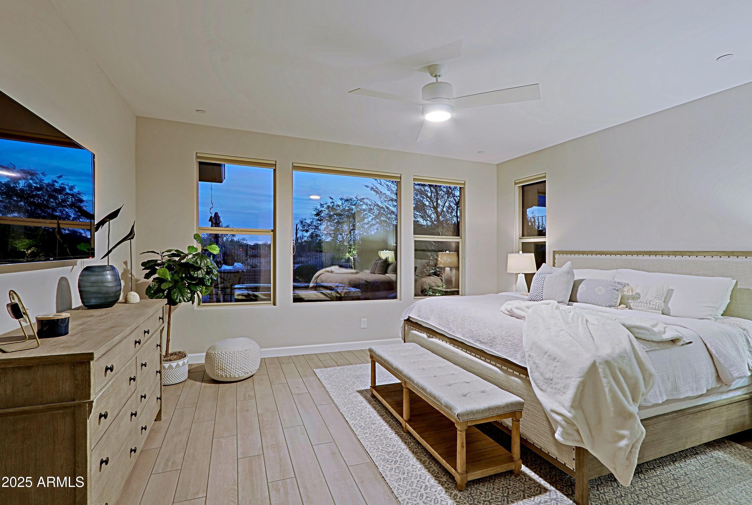 17811 East Cindercone Road Rio Verde, AZ 85263 - Photo 16 of 32 a bedroom with a bed and wooden floor