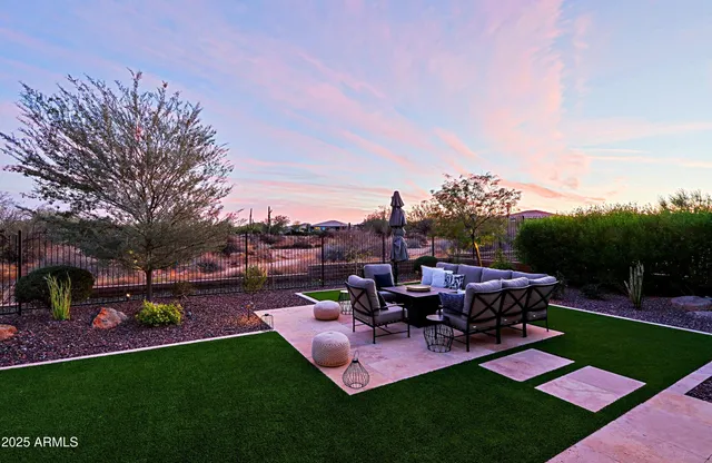 a view of a backyard with sitting area