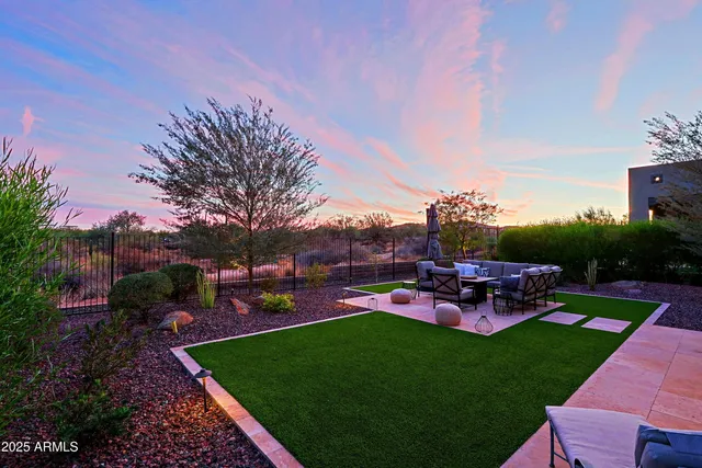 a view of a house with backyard porch and sitting area