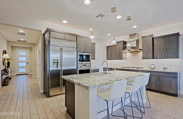 a large kitchen with a table and chairs