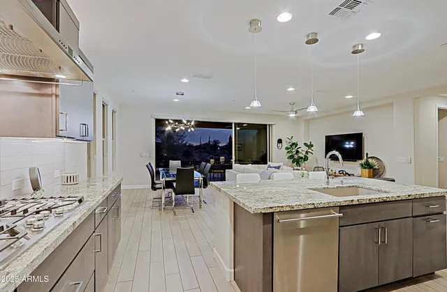 a kitchen with sink and view of living room