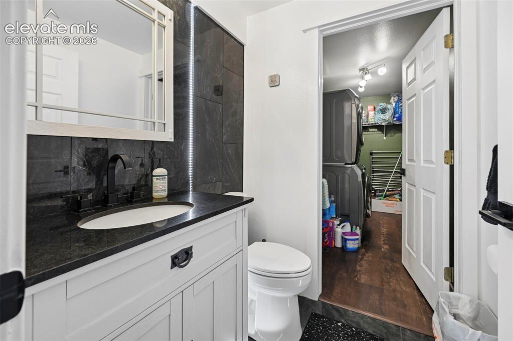 8347 Tibbs Road Peyton, CO 80831 - Photo 6 of 39 White shaker-style vanity with a dark countertop and integrated sink