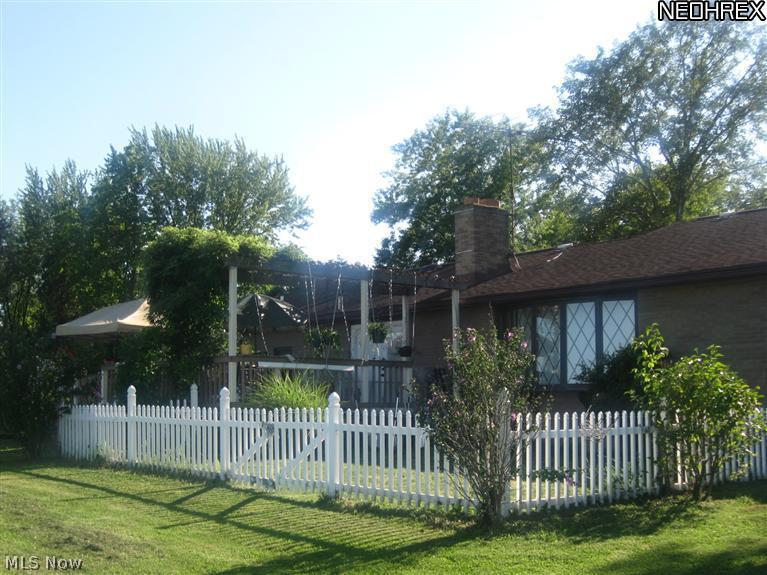 5631 Ledge Road Madison, OH 44057 - Photo 2 of 25 Back yard view of fenced in area and deck that over views the 105 acres of grapes and open space and woods. Nice for entertaining