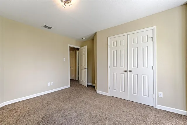 a view of an empty room with closet area