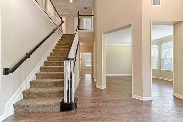a view of entryway and hall with wooden floor