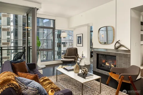 a living room with furniture a fireplace and window