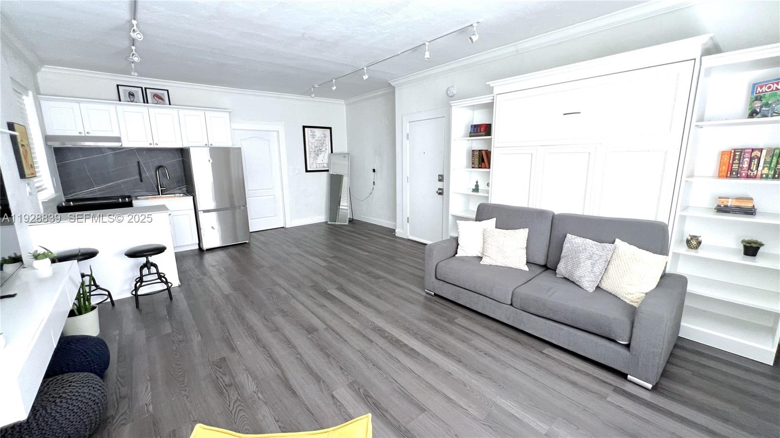 1115 Euclid Avenue, Unit 2 Miami Beach, FL 33139 - Photo 3 of 11 a living room with furniture and a flat screen tv