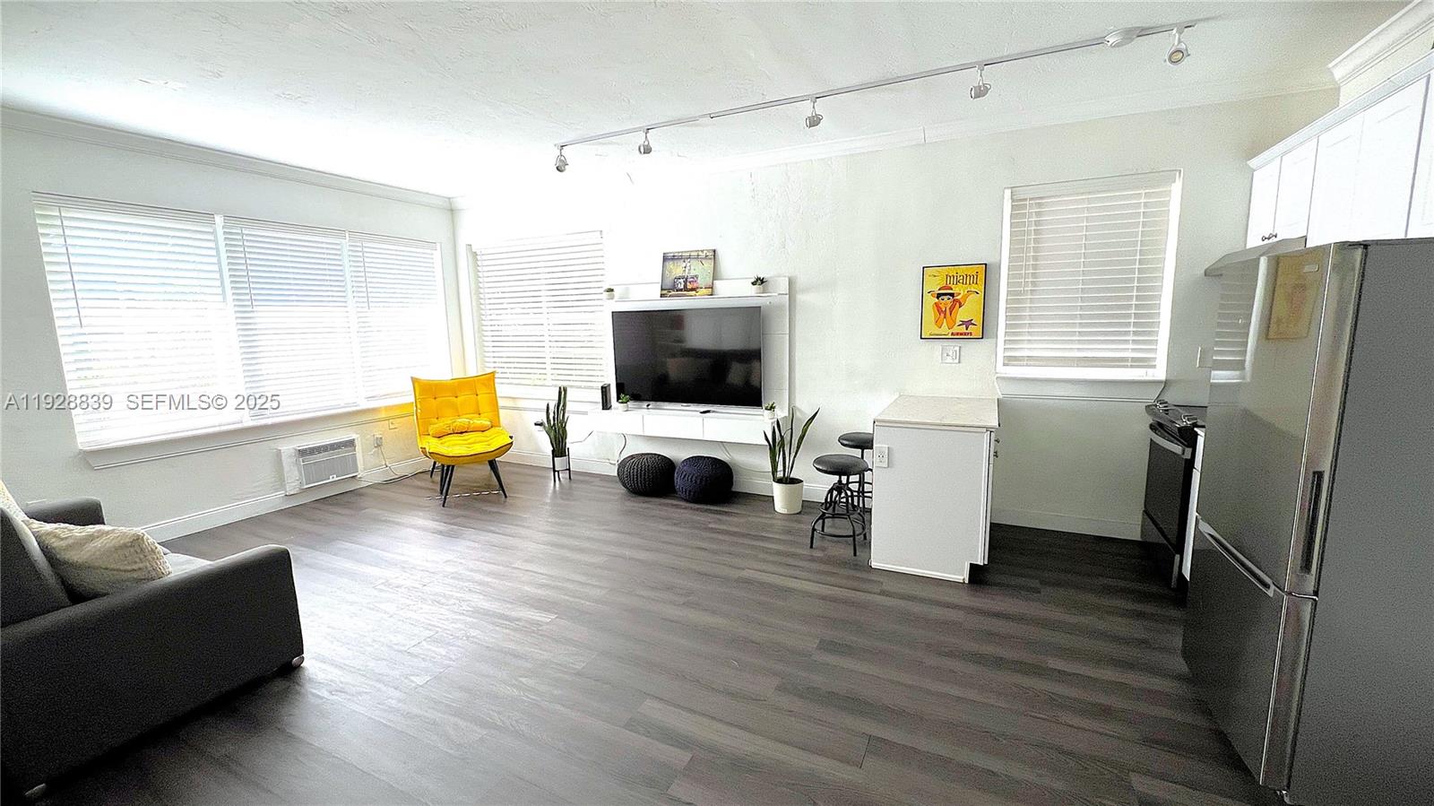 1115 Euclid Avenue, Unit 2 Miami Beach, FL 33139 - Photo 4 of 11 a living room with furniture and a flat screen tv