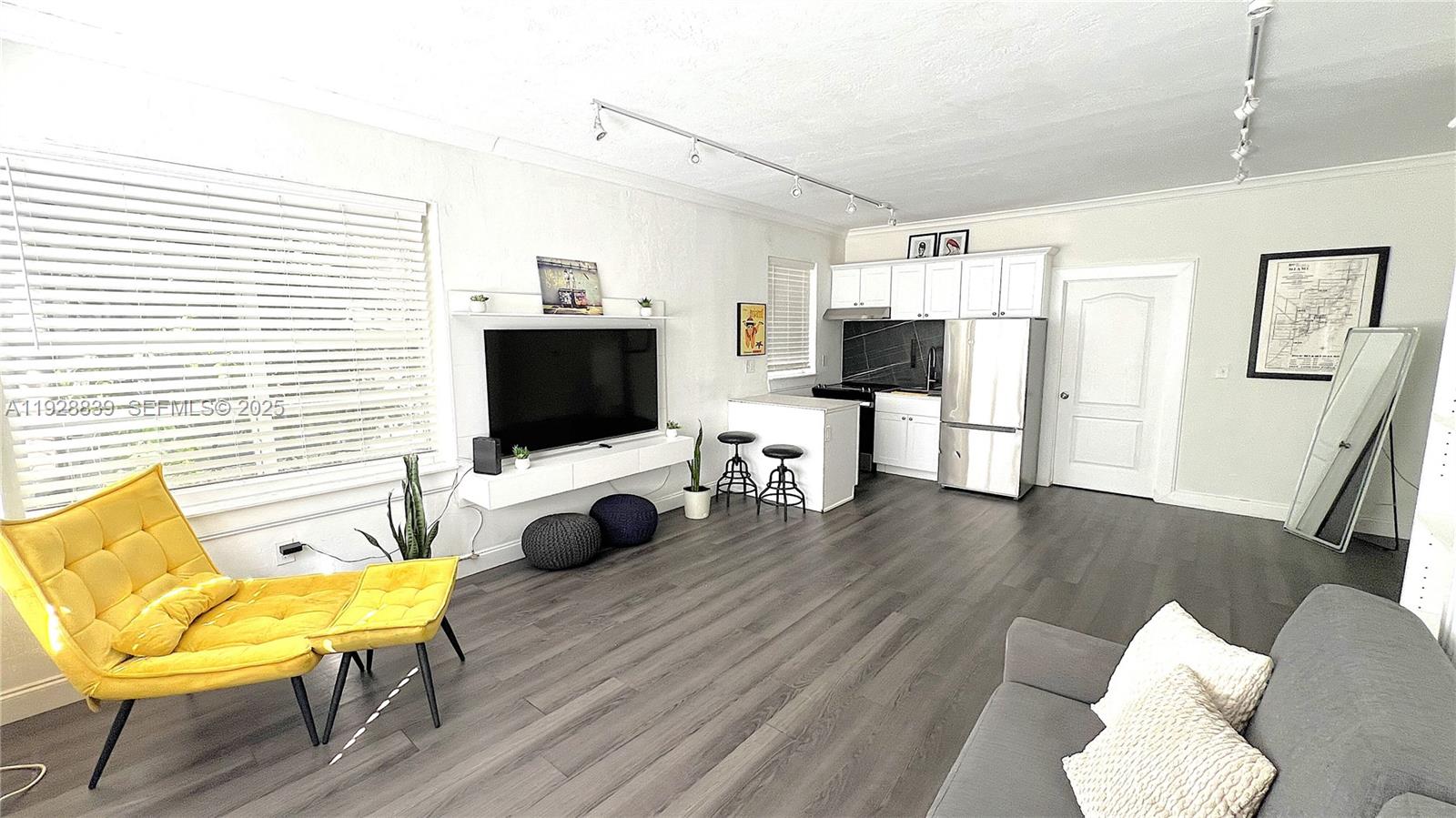 1115 Euclid Avenue, Unit 2 Miami Beach, FL 33139 - Photo 6 of 11 a living room with furniture and a flat screen tv