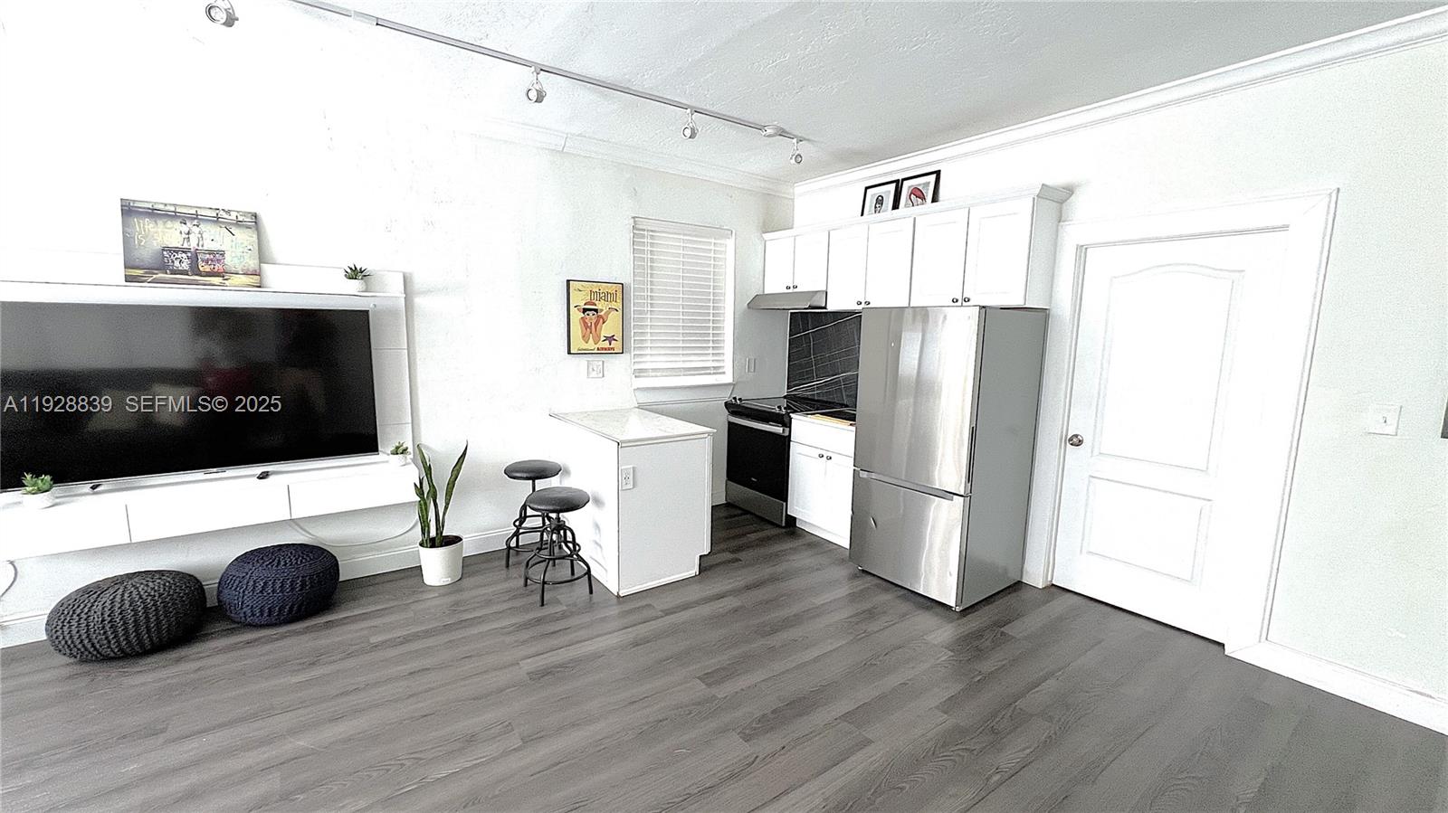 1115 Euclid Avenue, Unit 2 Miami Beach, FL 33139 - Photo 7 of 11 a kitchen with a refrigerator a stove a sink a counter space and cabinets