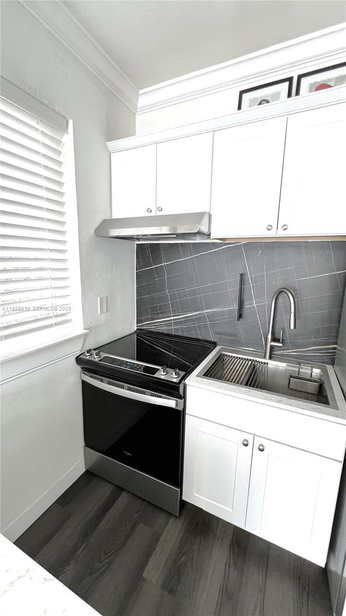1115 Euclid Avenue, Unit 2 Miami Beach, FL 33139 - Photo 9 of 11 a kitchen with a stove and a sink