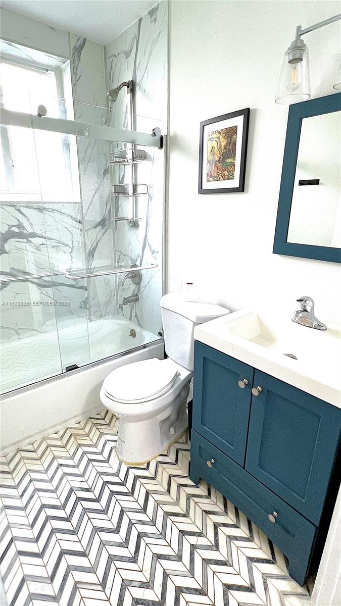 1115 Euclid Avenue, Unit 2 Miami Beach, FL 33139 - Photo 10 of 11 a bathroom with a toilet sink and mirror