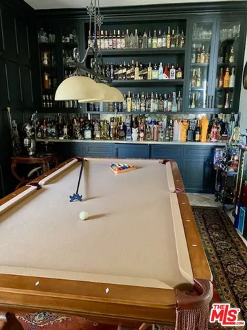 a view of a patio with couches and table and chairs with wooden fence