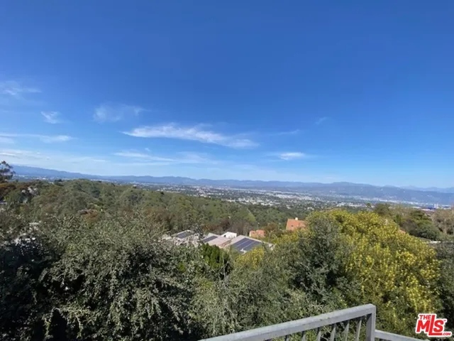 a view of a city with lush green forest