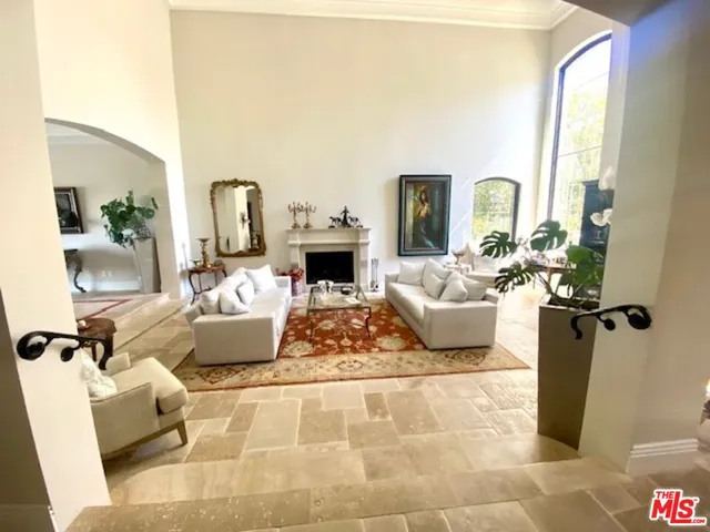 a living room with furniture flowerpot and a chandelier