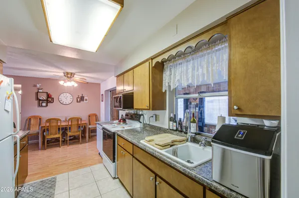 a kitchen with a sink and large windows