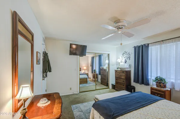 a bedroom with a bed and a flat screen tv