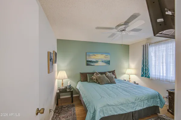 a bedroom with a bed and wooden floor