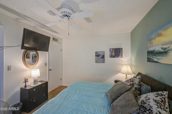 a bedroom with a bed and a flat screen tv