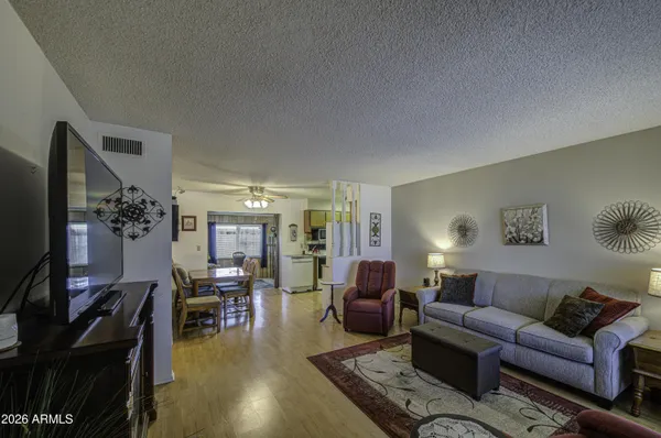 a living room with furniture a dining table and a flat screen tv