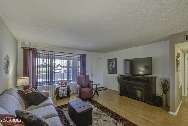 a living room with furniture a flat screen tv and a fireplace