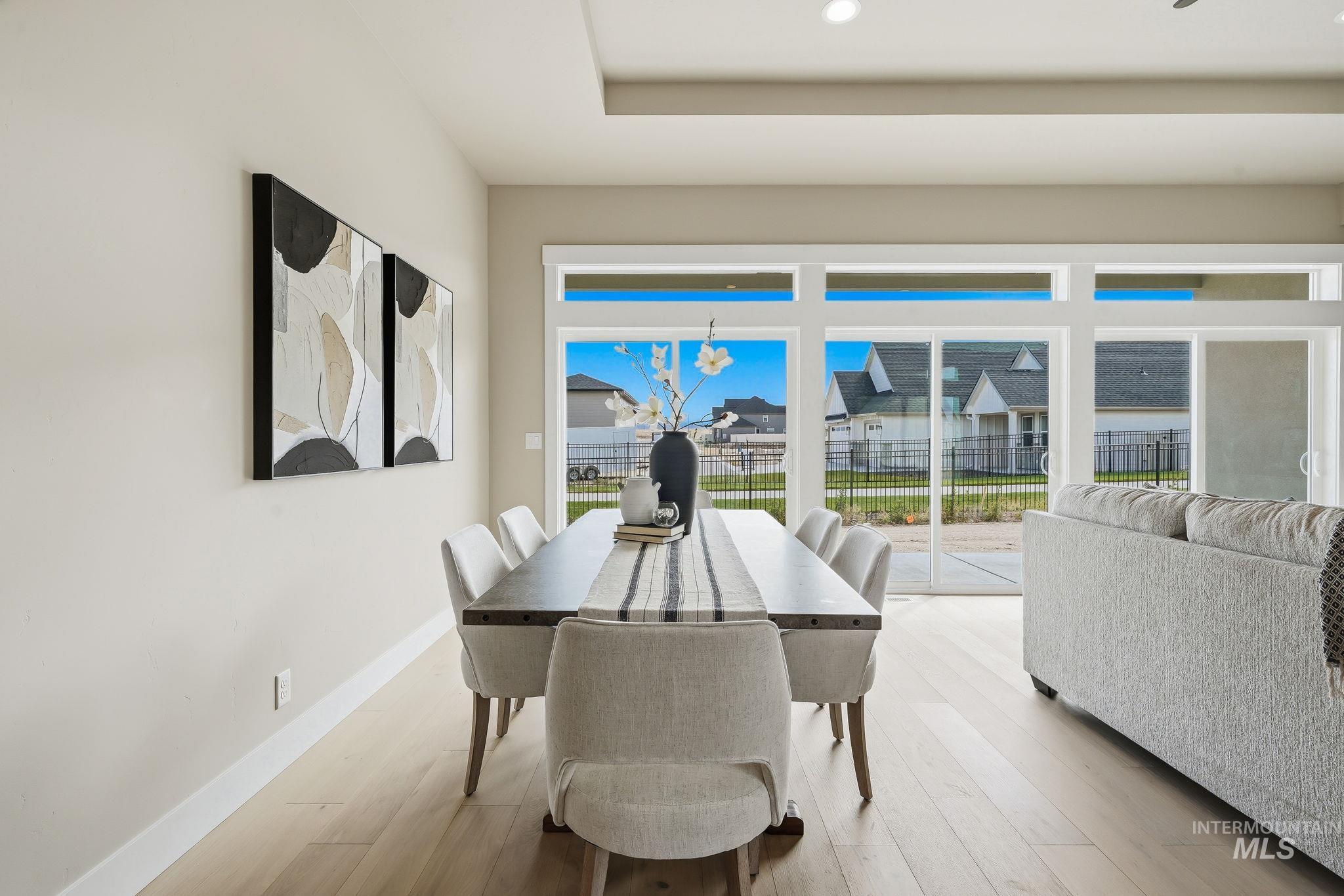 470 South Radiator Way Boise, ID 83716 - Photo 15 of 50 Dining area featuring light wood-finish flooring, recessed ceiling lighting, and a contemporary light gray wall color