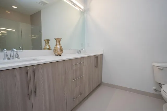 a kitchen with a sink and a toilet