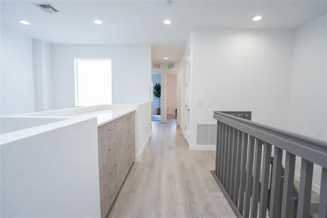a view of hallway with wooden floor