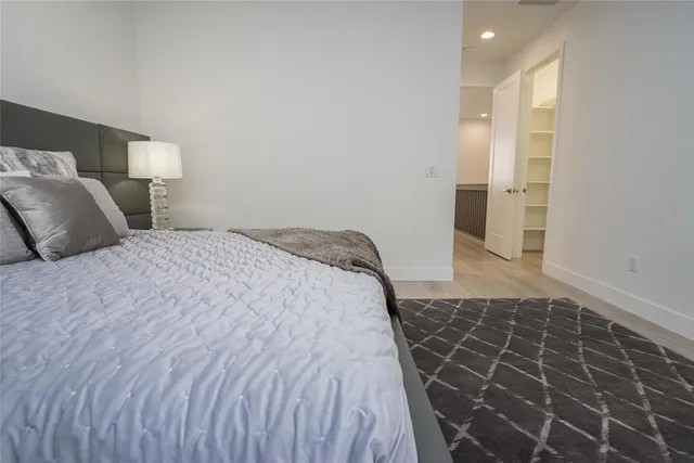 a bedroom with a bed and a shower