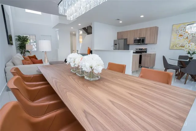 a living room with kitchen island furniture and a chandelier