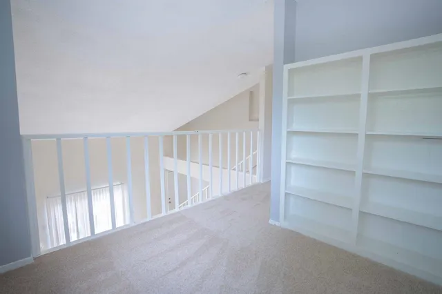 a view of an empty room with stairs