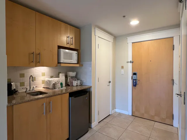 a kitchen with stainless steel appliances granite countertop a refrigerator and a sink
