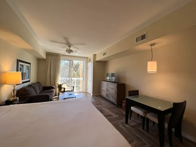 a living room with furniture a window and a flat screen tv