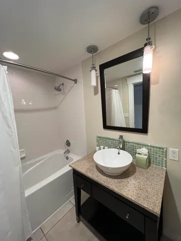 a bedroom with a bed and a lamp