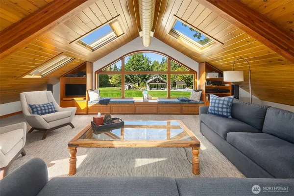 a living room with patio furniture and a large window