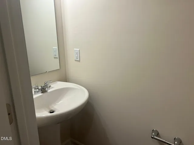 a bathroom with a sink and mirror