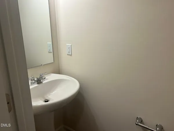 a bathroom with a sink and mirror