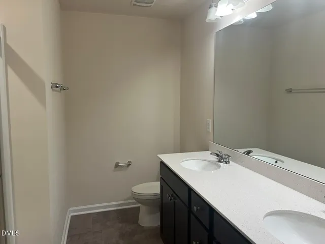 a bathroom with a sink toilet and vanity