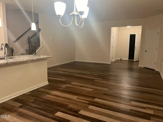 a view of a room with wooden floor and staircase