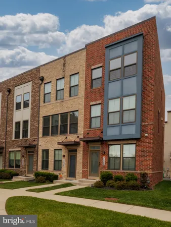 a front view of a residential apartment building with a yard