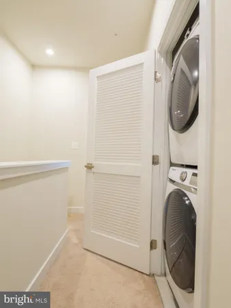 a view of a storage & utility room with a washer dryer