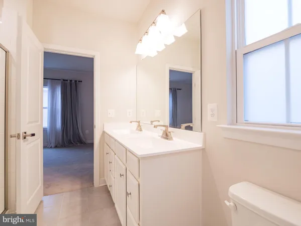 a bathroom with a double vanity sink and a mirror