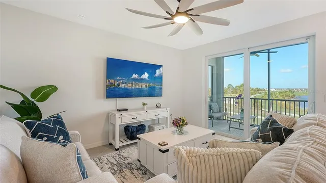 a view of a balcony with furniture and floor to ceiling window